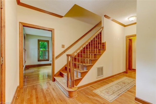 6400 Muirfield Dr, Greensboro, NC 27410 - stairs with wood finished floors and crown molding