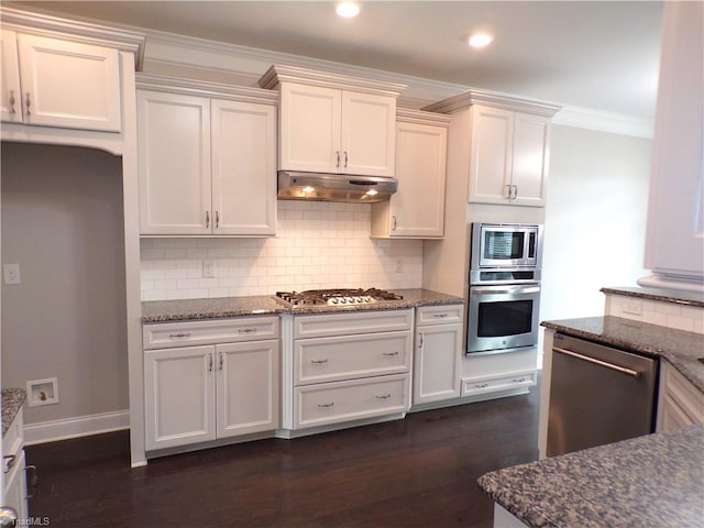 8003 Helison Ct, Stokesdale, NC 27357 - kitchen featuring stainless steel appliances, dark stone counters, ornamental molding, under cabinet range hood, and backsplash