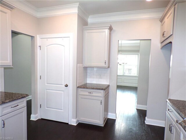8003 Helison Ct, Stokesdale, NC 27357 - kitchen featuring dark wood-style floors, crown molding, dark stone countertops, backsplash, and baseboards