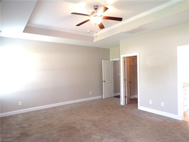 8003 Helison Ct, Stokesdale, NC 27357 - unfurnished bedroom featuring a raised ceiling, baseboards, crown molding, carpet floors, and a spacious closet