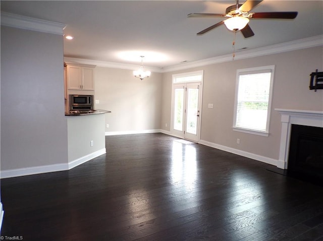 8003 Helison Ct, Stokesdale, NC 27357 - unfurnished living room with a fireplace, a chandelier, dark wood finished floors, ceiling fan, and ornamental molding