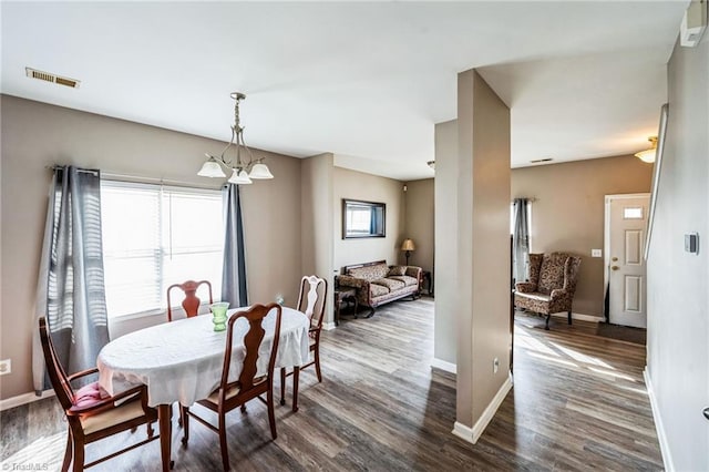 dining area featuring dark wood-type flooring and a healthy amount of sunlight