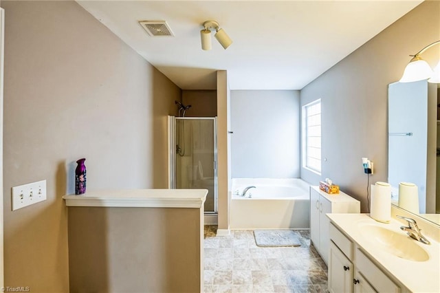 bathroom featuring independent shower and bath and vanity