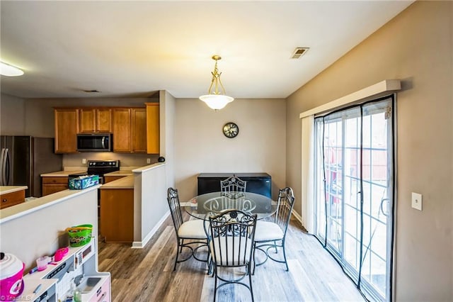 dining area featuring light wood-type flooring