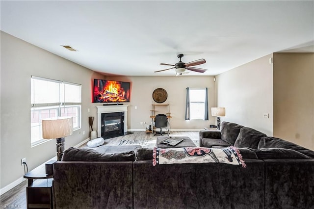 living room featuring ceiling fan and hardwood / wood-style floors