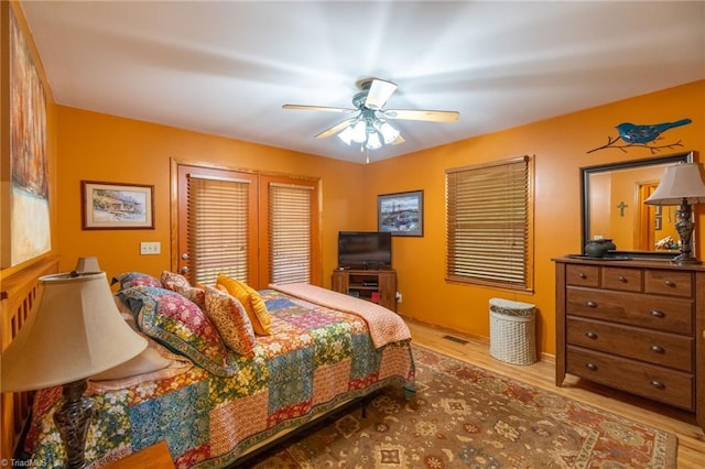 bedroom with ceiling fan and light wood-type flooring