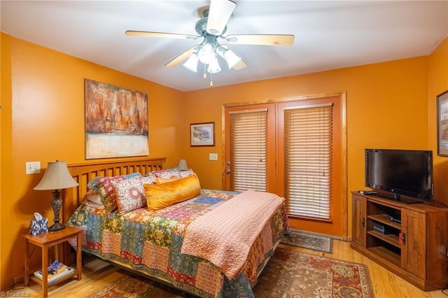 bedroom with light hardwood / wood-style floors and ceiling fan