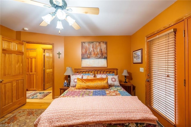 bedroom with light hardwood / wood-style floors and ceiling fan