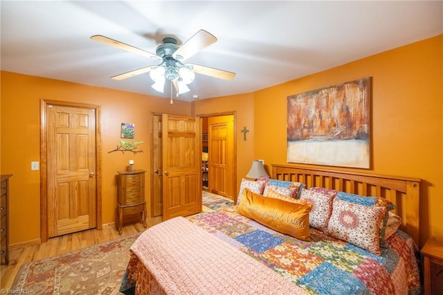 bedroom with ceiling fan and light hardwood / wood-style floors