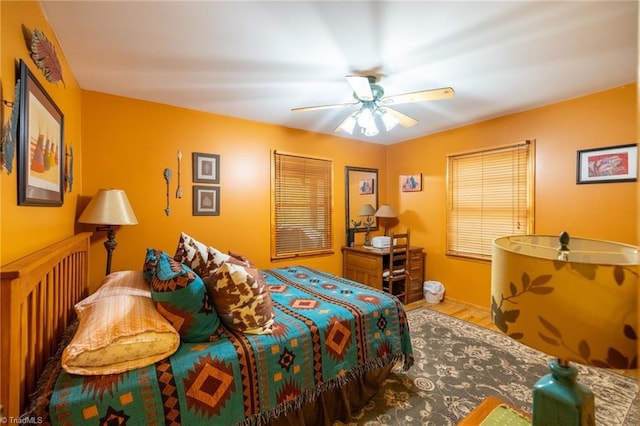 bedroom with ceiling fan and hardwood / wood-style floors