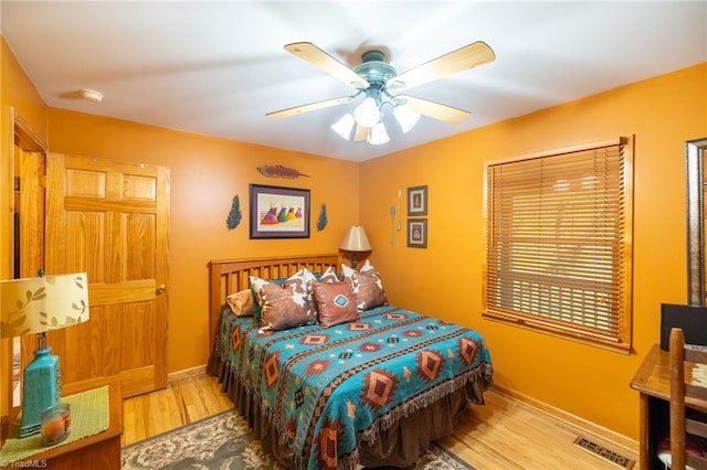 bedroom with ceiling fan and hardwood / wood-style floors