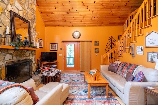 living room with a stone fireplace, wood ceiling, and vaulted ceiling