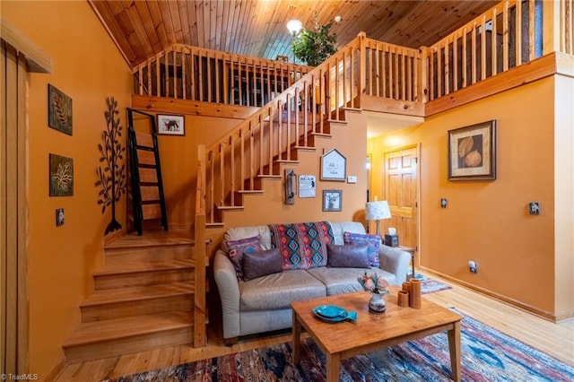 living room with high vaulted ceiling, wooden ceiling, and hardwood / wood-style floors