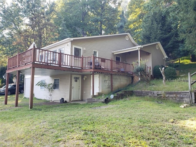 rear view of property with a lawn and a wooden deck