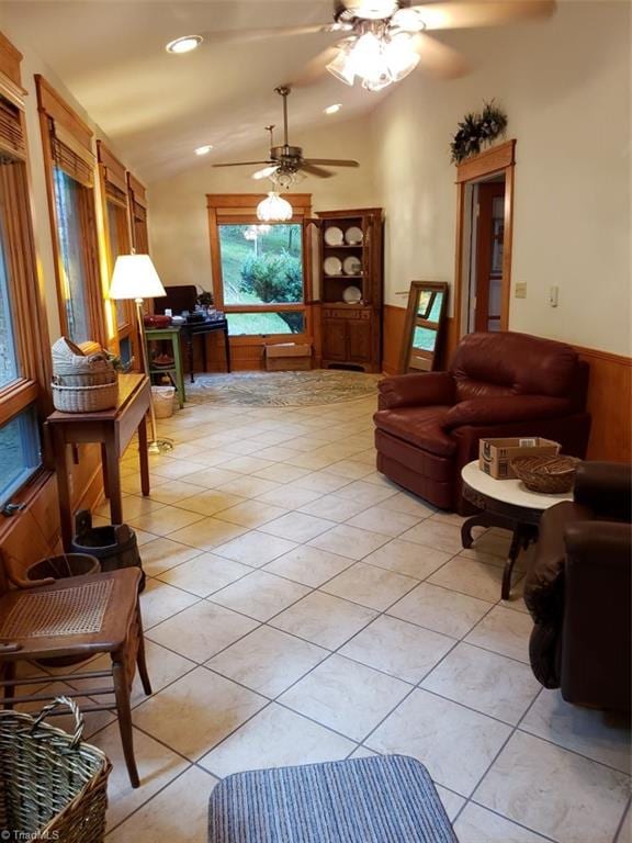 tiled living room featuring ceiling fan and vaulted ceiling