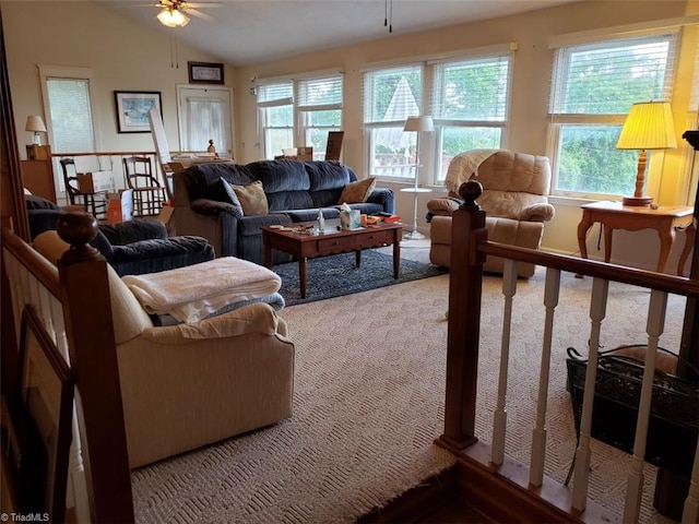 living room featuring carpet flooring, ceiling fan, a healthy amount of sunlight, and vaulted ceiling