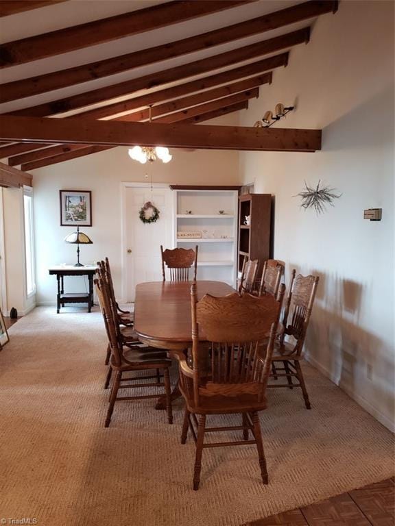 dining space with lofted ceiling with beams and carpet floors