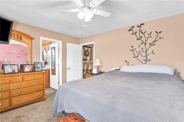 carpeted bedroom featuring a textured ceiling and ceiling fan