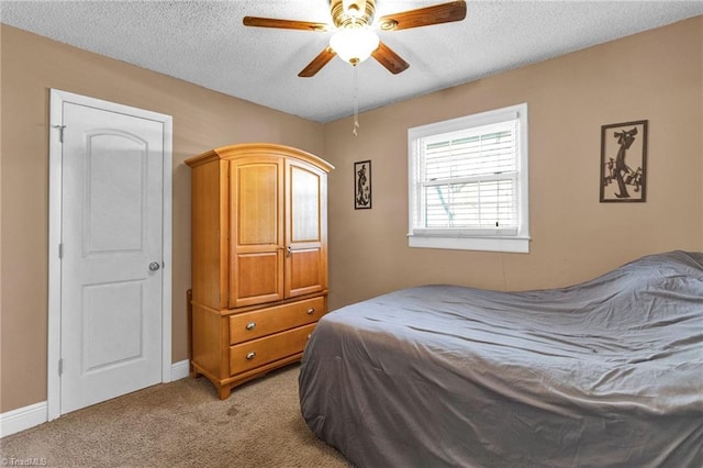 carpeted bedroom with a textured ceiling and ceiling fan