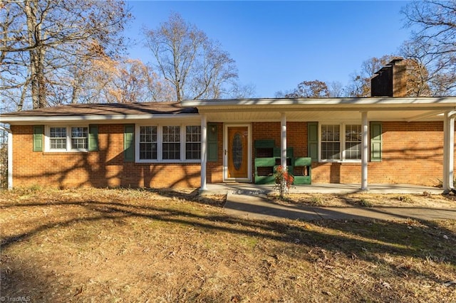 rear view of property with a porch