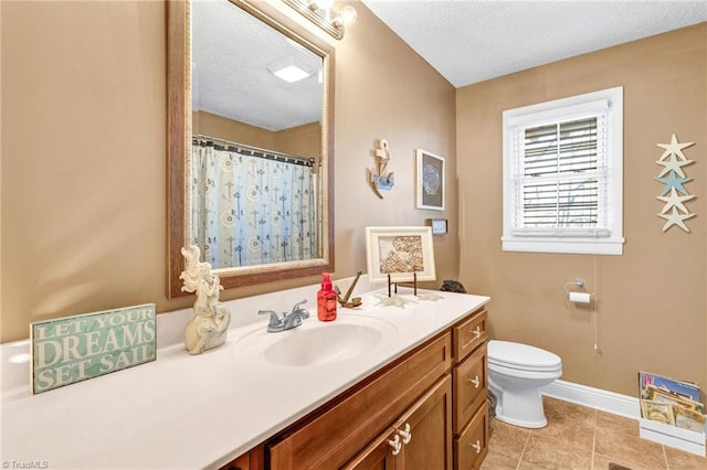 bathroom with vanity, tile patterned floors, a shower with curtain, toilet, and a textured ceiling