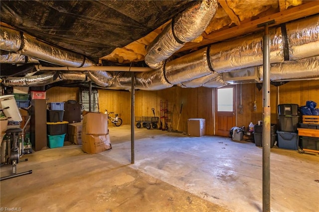 basement featuring wood walls