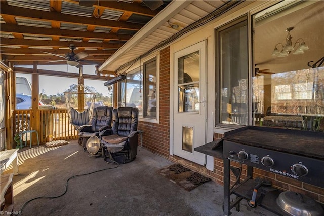 sunroom with ceiling fan, a healthy amount of sunlight, and vaulted ceiling