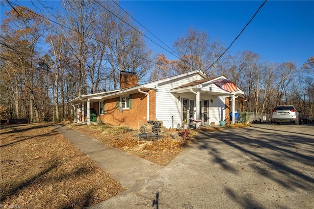 view of side of home with covered porch