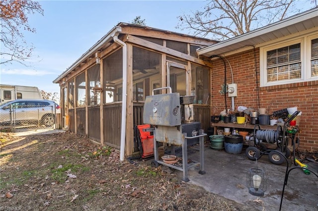 view of property exterior featuring a sunroom