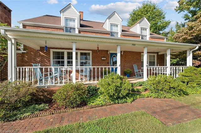 rear view of property featuring a porch