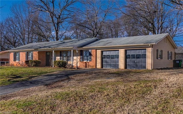 ranch-style home featuring a front yard and a garage