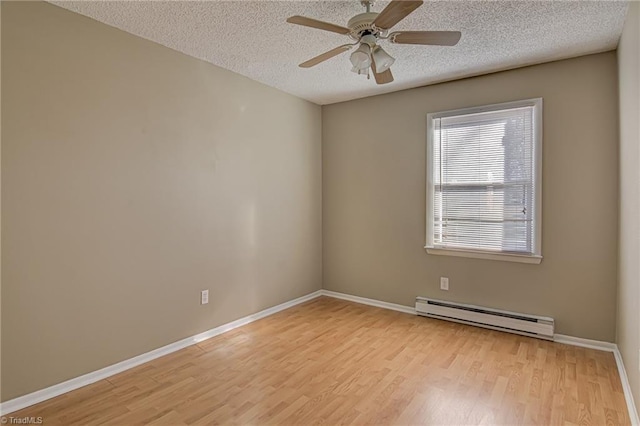 spare room featuring ceiling fan, light wood-type flooring, a textured ceiling, and a baseboard radiator