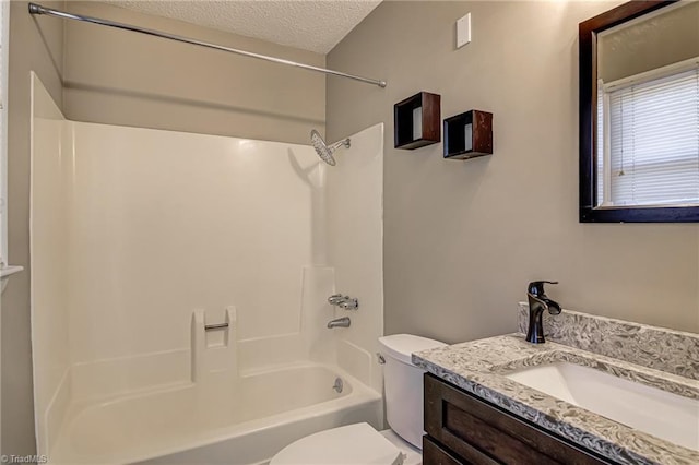 full bathroom featuring vanity, toilet, a textured ceiling, and shower / washtub combination