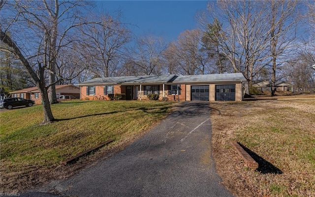 ranch-style home with a garage and a front lawn