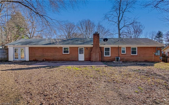 rear view of property with central AC and french doors