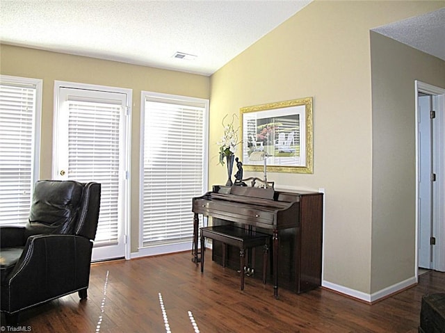 sitting room featuring wood finished floors, visible vents, and a textured ceiling