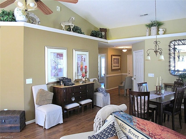 dining room featuring a ceiling fan, baseboards, wood finished floors, visible vents, and high vaulted ceiling