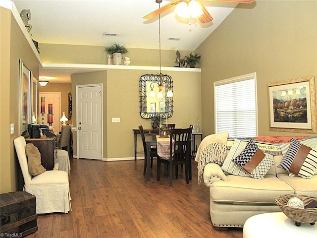 living room featuring visible vents, wood finished floors, and ceiling fan with notable chandelier