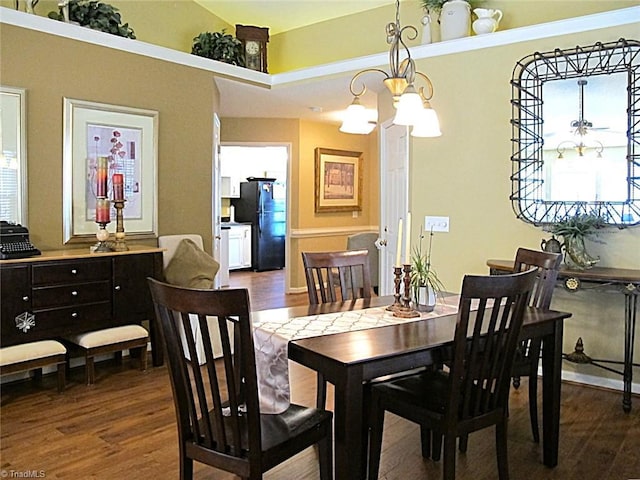 dining room featuring dark wood-type flooring and a chandelier