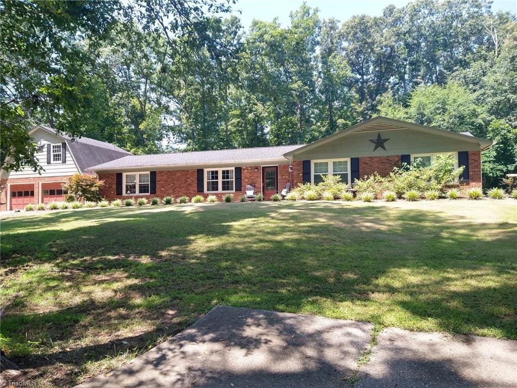 3977 Shannon Dr, Trinity, NC 27370 - view of front of home with brick siding and a front yard