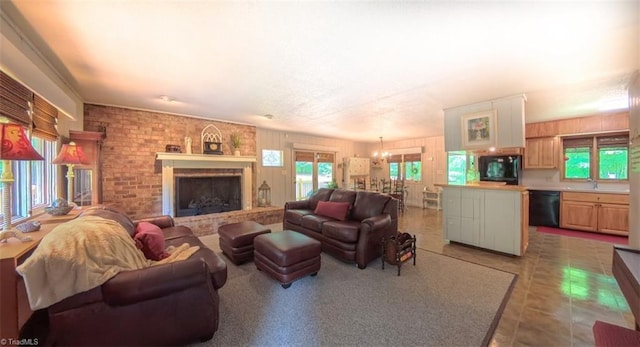 235 Hogan Bowers Rd, Thomasville, NC 27360 - living room featuring a brick fireplace and a chandelier