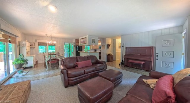 235 Hogan Bowers Rd, Thomasville, NC 27360 - living area featuring a chandelier, wooden walls, and a textured ceiling