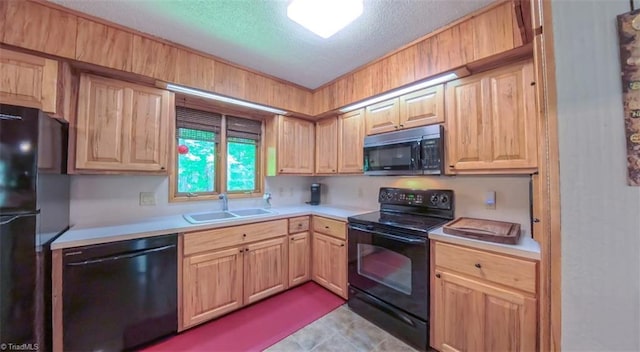 235 Hogan Bowers Rd, Thomasville, NC 27360 - kitchen featuring black appliances, a sink, light brown cabinets, light countertops, and a textured ceiling