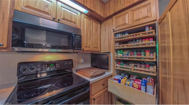 235 Hogan Bowers Rd, Thomasville, NC 27360 - kitchen with black electric range oven and brown cabinets
