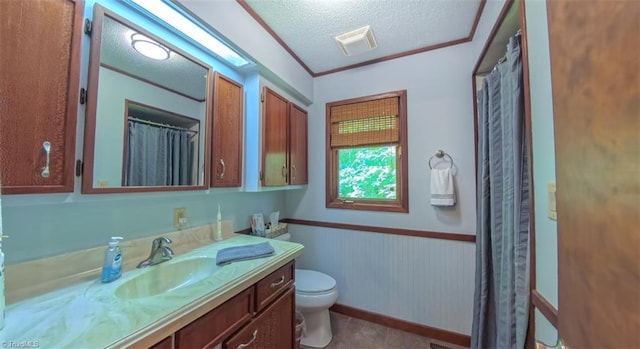 235 Hogan Bowers Rd, Thomasville, NC 27360 - bathroom with vanity, a textured ceiling, toilet, and a wainscoted wall