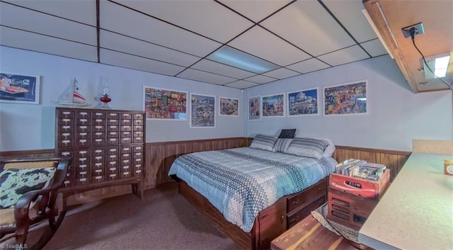 235 Hogan Bowers Rd, Thomasville, NC 27360 - bedroom with a wainscoted wall, carpet floors, a paneled ceiling, and wood walls