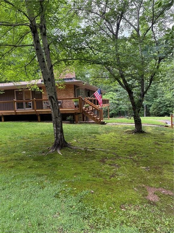 235 Hogan Bowers Rd, Thomasville, NC 27360 - view of grassy yard featuring a wooden deck and stairway