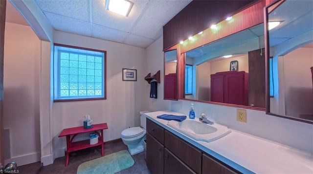 235 Hogan Bowers Rd, Thomasville, NC 27360 - bathroom with toilet, vanity, a drop ceiling, and baseboards