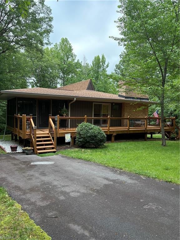 235 Hogan Bowers Rd, Thomasville, NC 27360 - view of front facade with a deck, a front yard, and a chimney