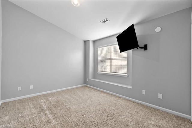 unfurnished room featuring carpet floors, baseboards, and visible vents